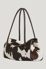 White and brown cow-print ponyhair E/W shoulder bag — model side