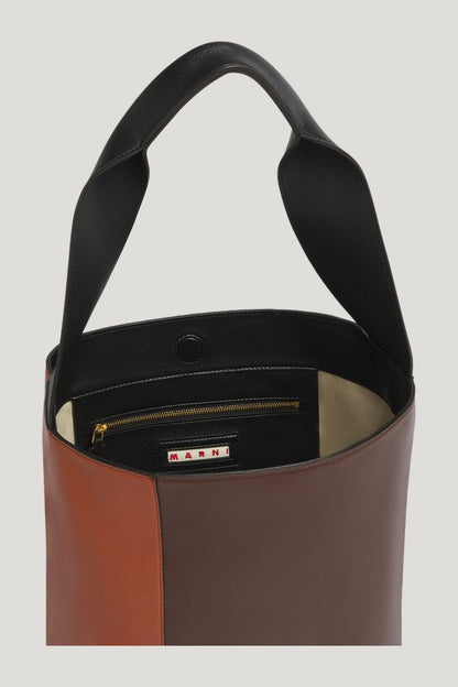Light brown, dark brown and black leather Pod 2.0 bag — model side